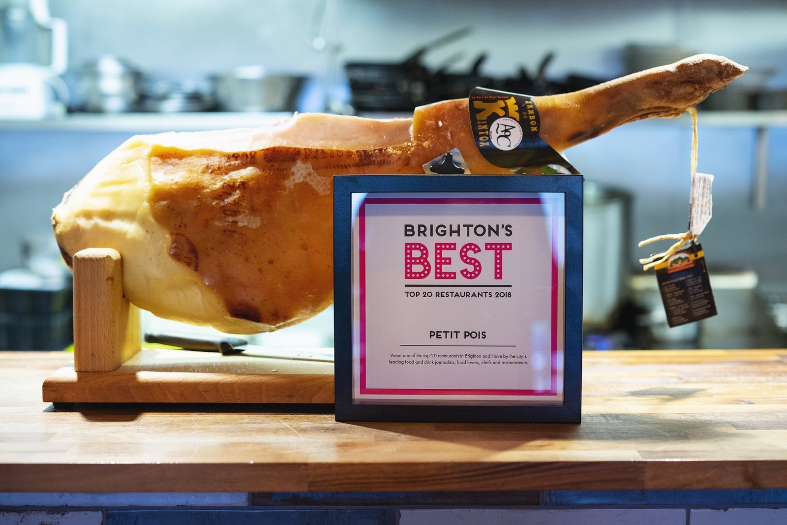A whole leg of Bayonne ham on a wooden stand beside the kitchen