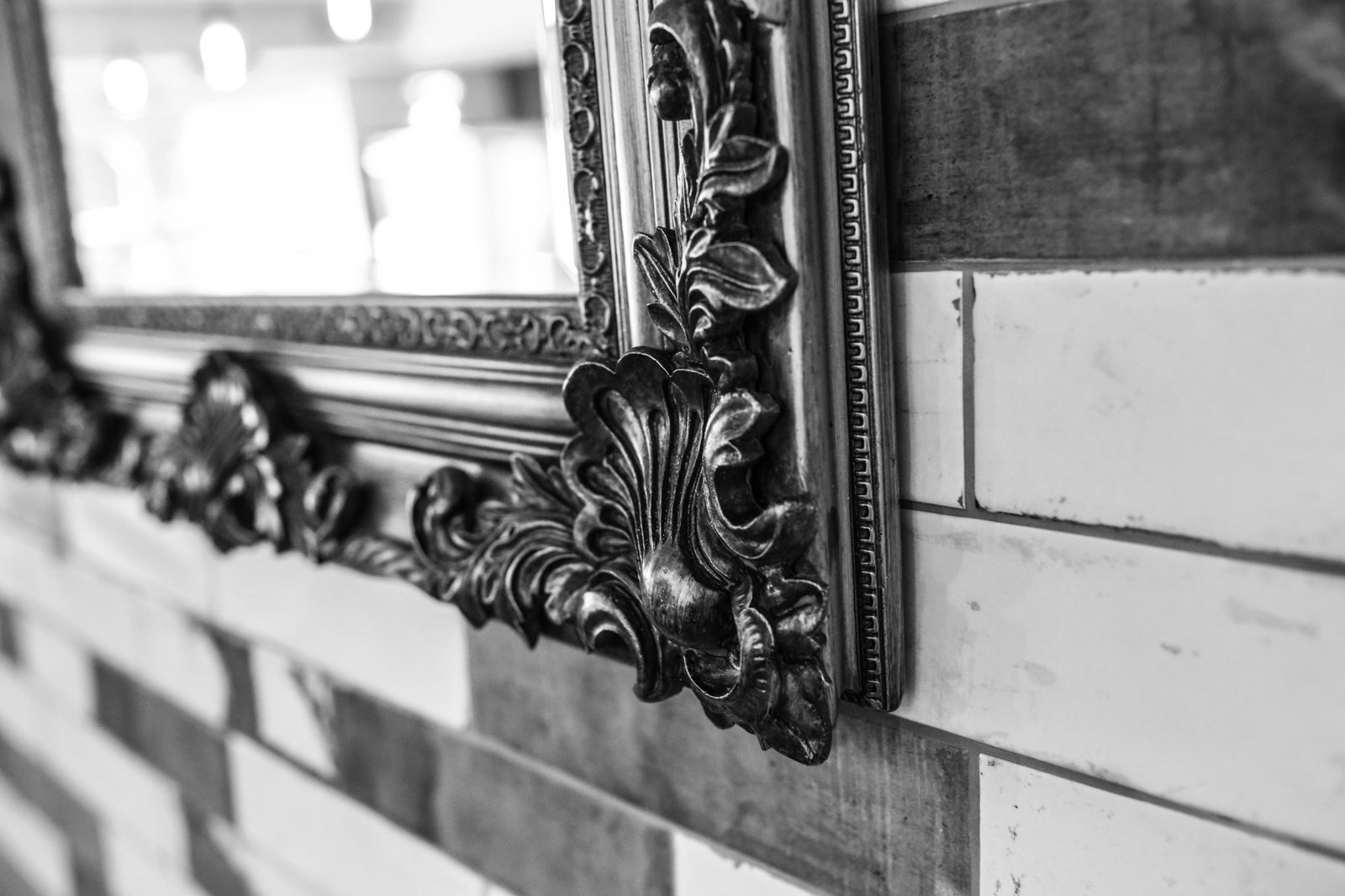 Ornate gilded mirror above blue and white tiles inside the dining room