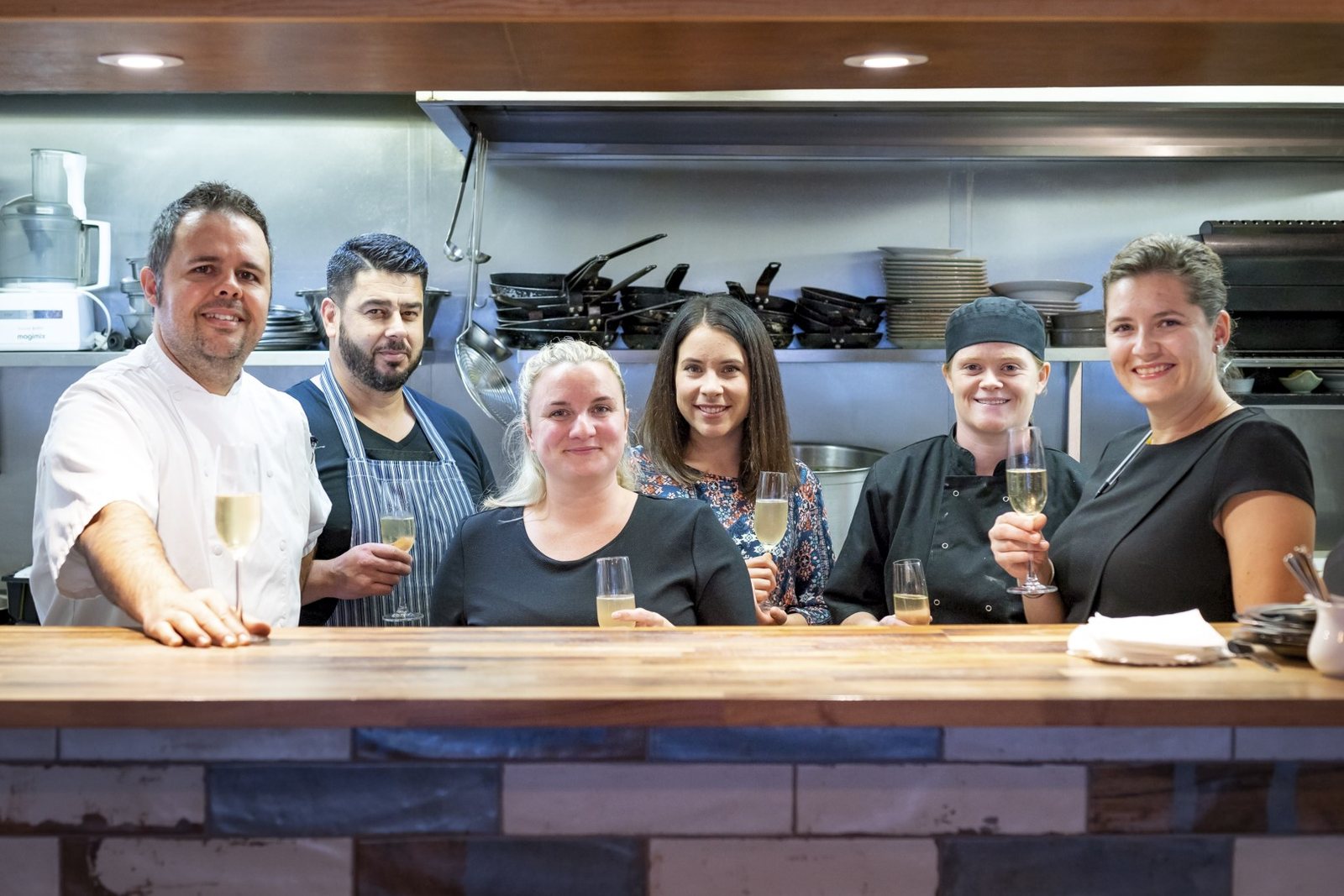 The team at the kitchen pass plating dishes