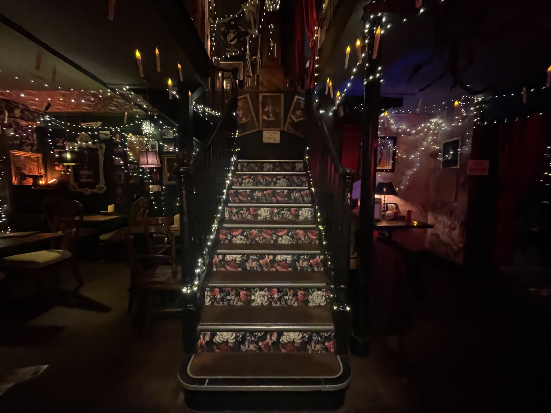 Table set with tarot-style cards, black candles and curiosities at ThewitchEZ